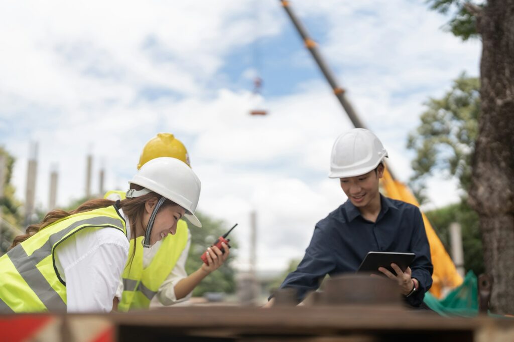 Young construction engineer people working together at the building site place background